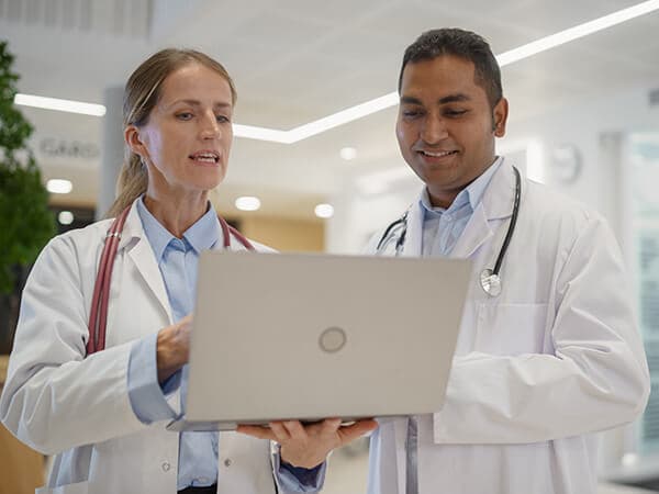 Business Healthcare Features 600x450 Healthcare workers looking at a laptop computer together