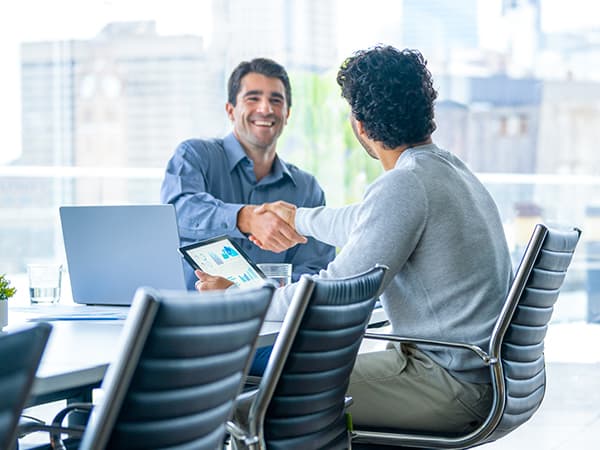 Business Professional Services Features 600x450 Two men in conference room shaking hands