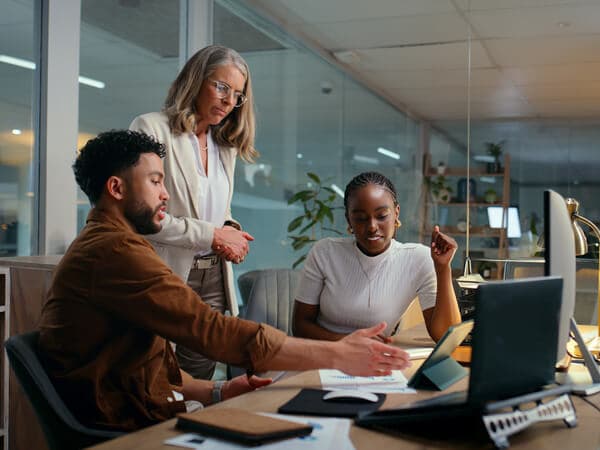 Business Single Provider Features 600x450 Group of three co-workers looking at something on a tablet